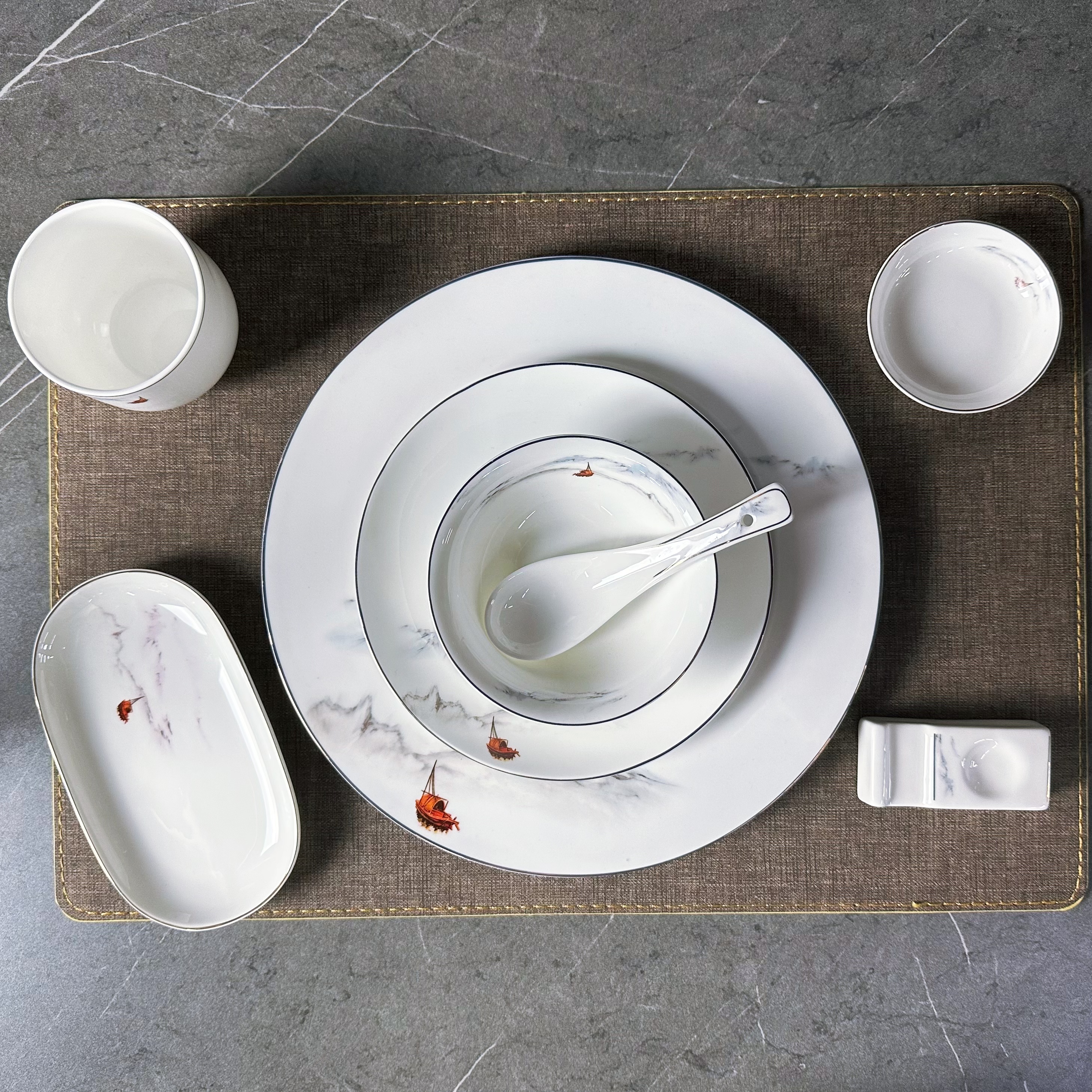 The "Flowing Clouds and Flowing Water" series high-bone meal content bone China tableware set is designed for Chinese ink-wash style hotel table setting and banquets