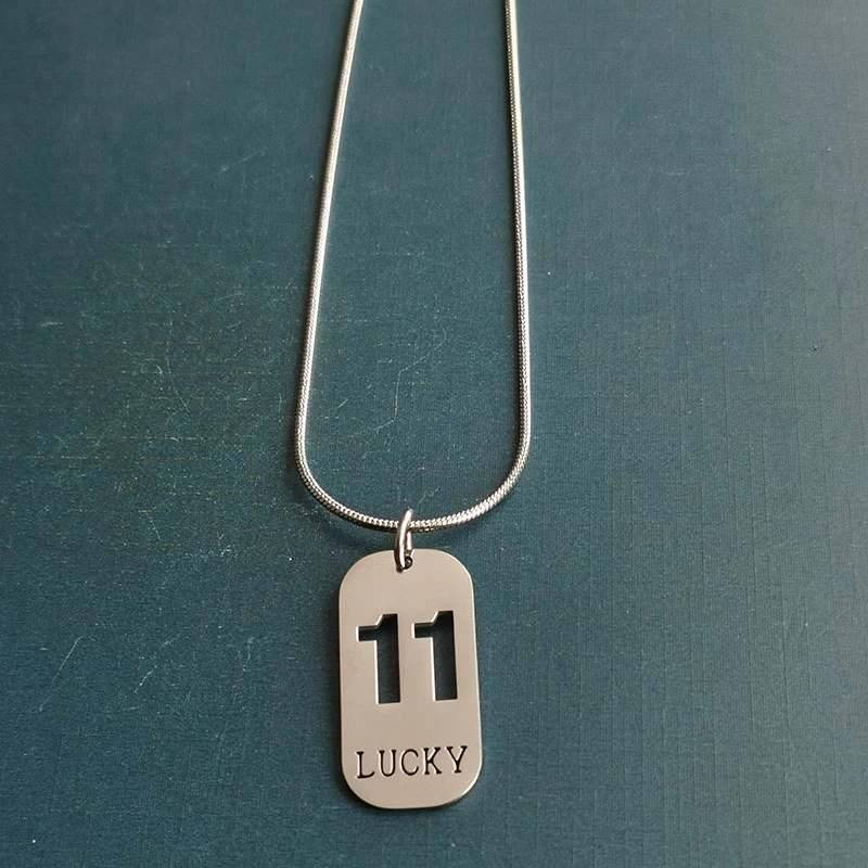 Cross-border foreign trade hollowed-out lucky number eleven keychain, brushed military brand titanium steel stainless steel necklace pendant detail image 9