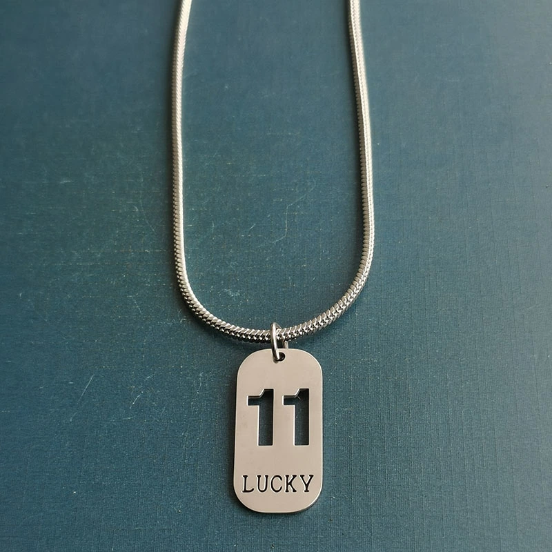 Cross-border foreign trade hollowed-out lucky number eleven keychain, brushed military brand titanium steel stainless steel necklace pendant detail image 7