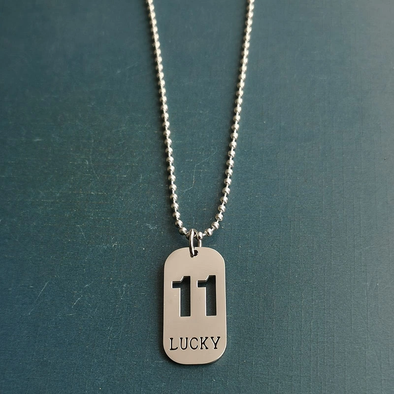 Cross-border foreign trade hollowed-out lucky number eleven keychain, brushed military brand titanium steel stainless steel necklace pendant detail image 4