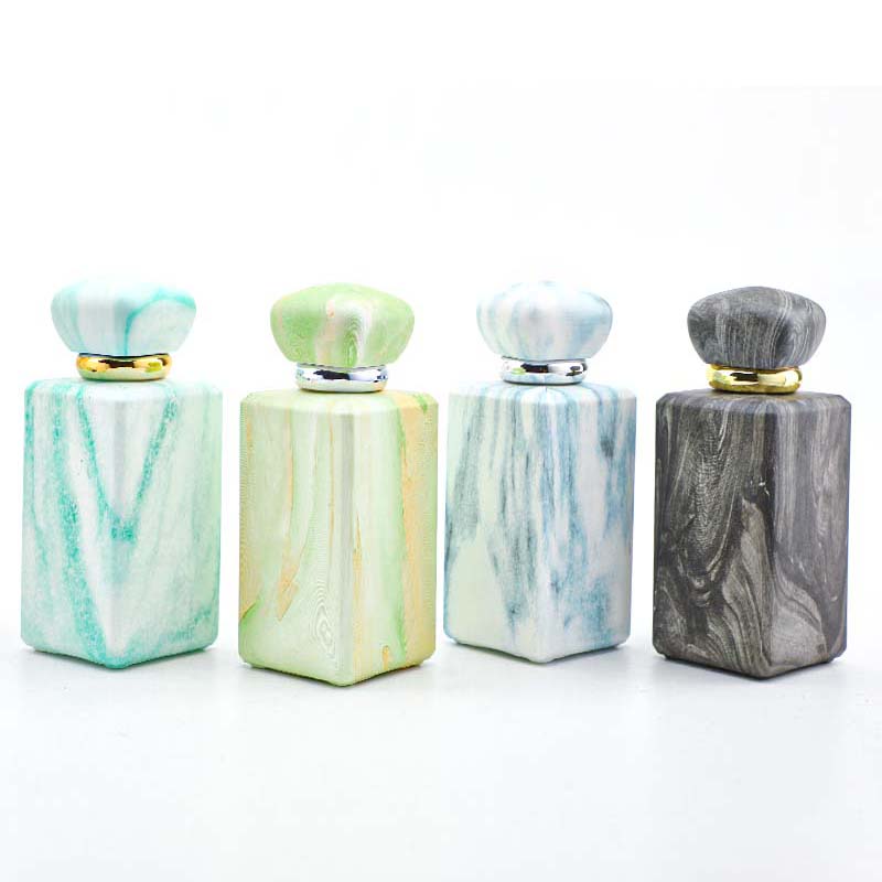 The manufacturer custom-made 100ml perfume bottle with a thickened press-type nozzle. It features a niche design and a thickened bottom in four colors