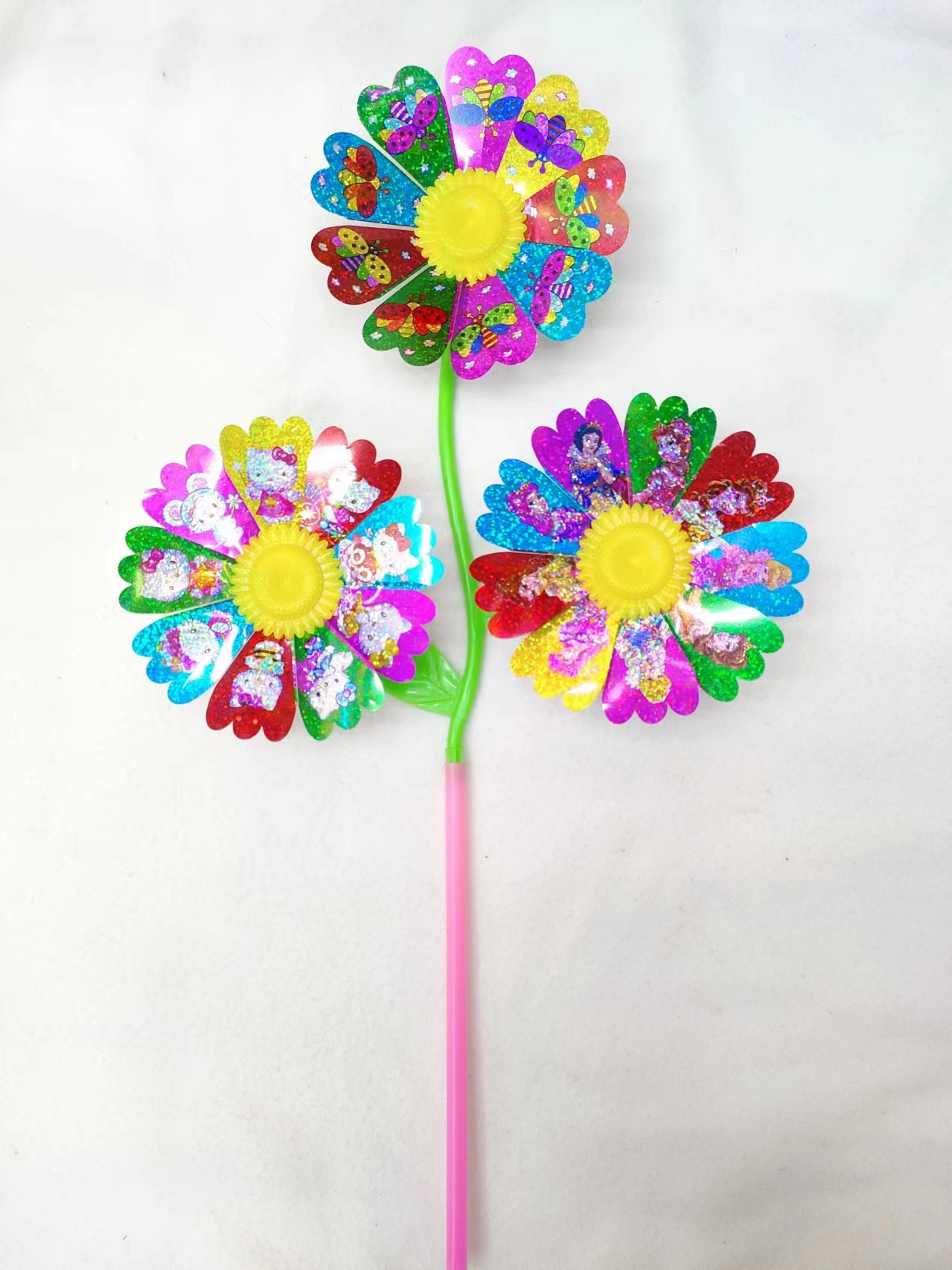 Three sequined cartoon sunflowers, a traditional and nostalgic cartoon toy