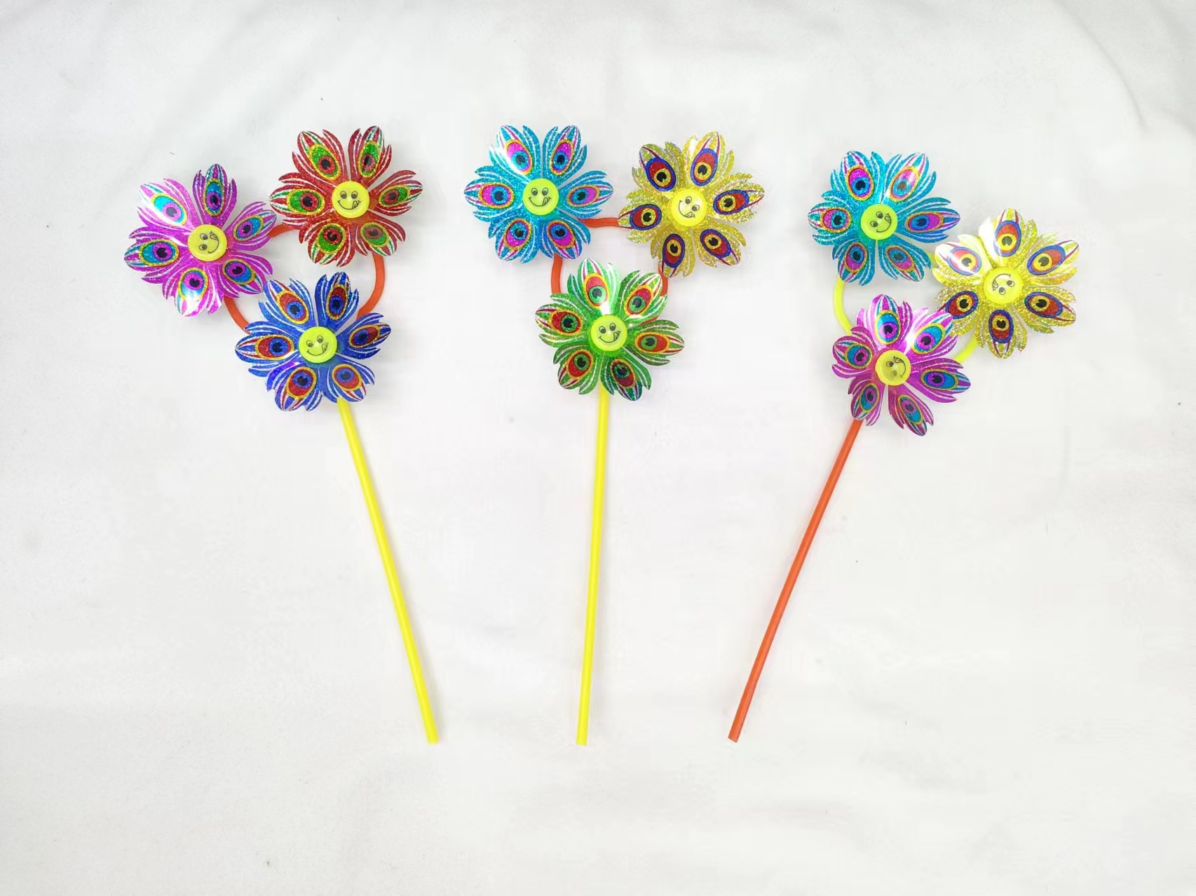 The three-wheeled smiling face sequined street stall is selling well. Windmill toys, small windmills for photos, swinging and rotating, are children's favorite toys. The bright colors are eye-catching. Windmill toys are selling well at the street stall