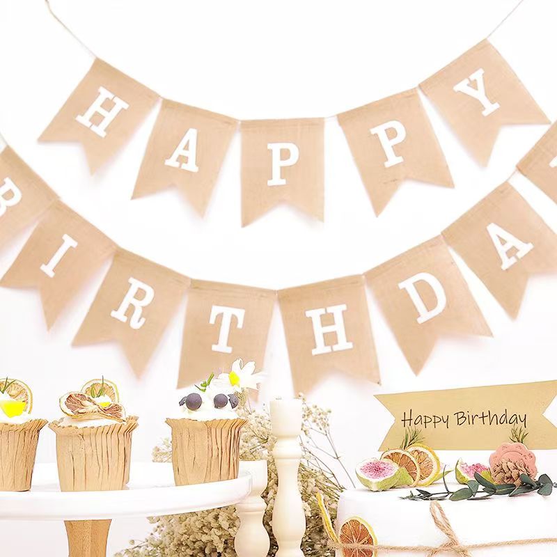 The background wall is decorated with flowered and colorful flags for the 100-day birthday party of babies and children in linen and swallowtail flags details Picture
