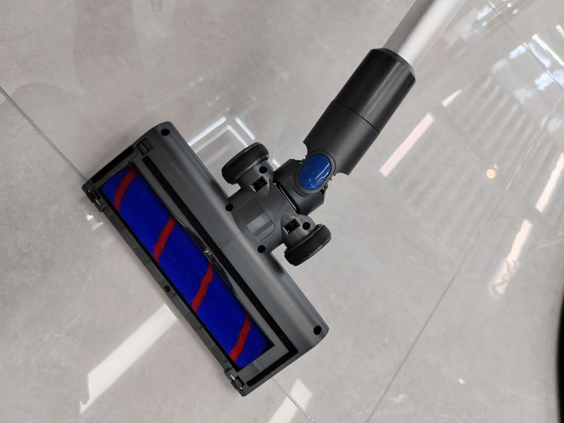 High-efficiency vacuum cleaner with accessories set on modern floor