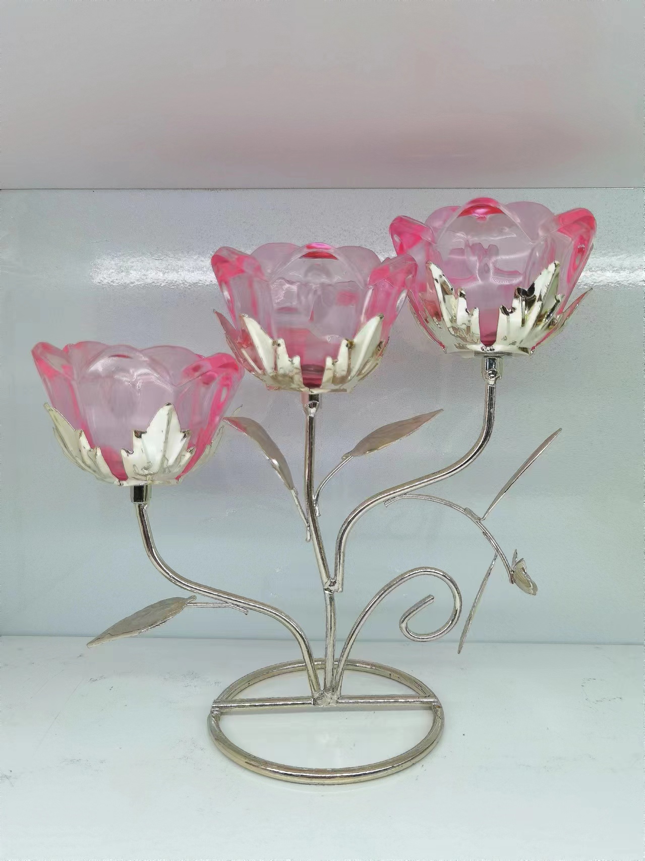 ثلاث شمعدانات زجاجية بإطار حديدي