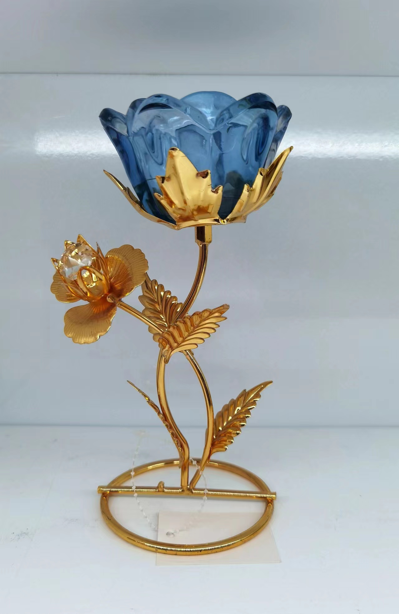 One iron-framed glass candlestick