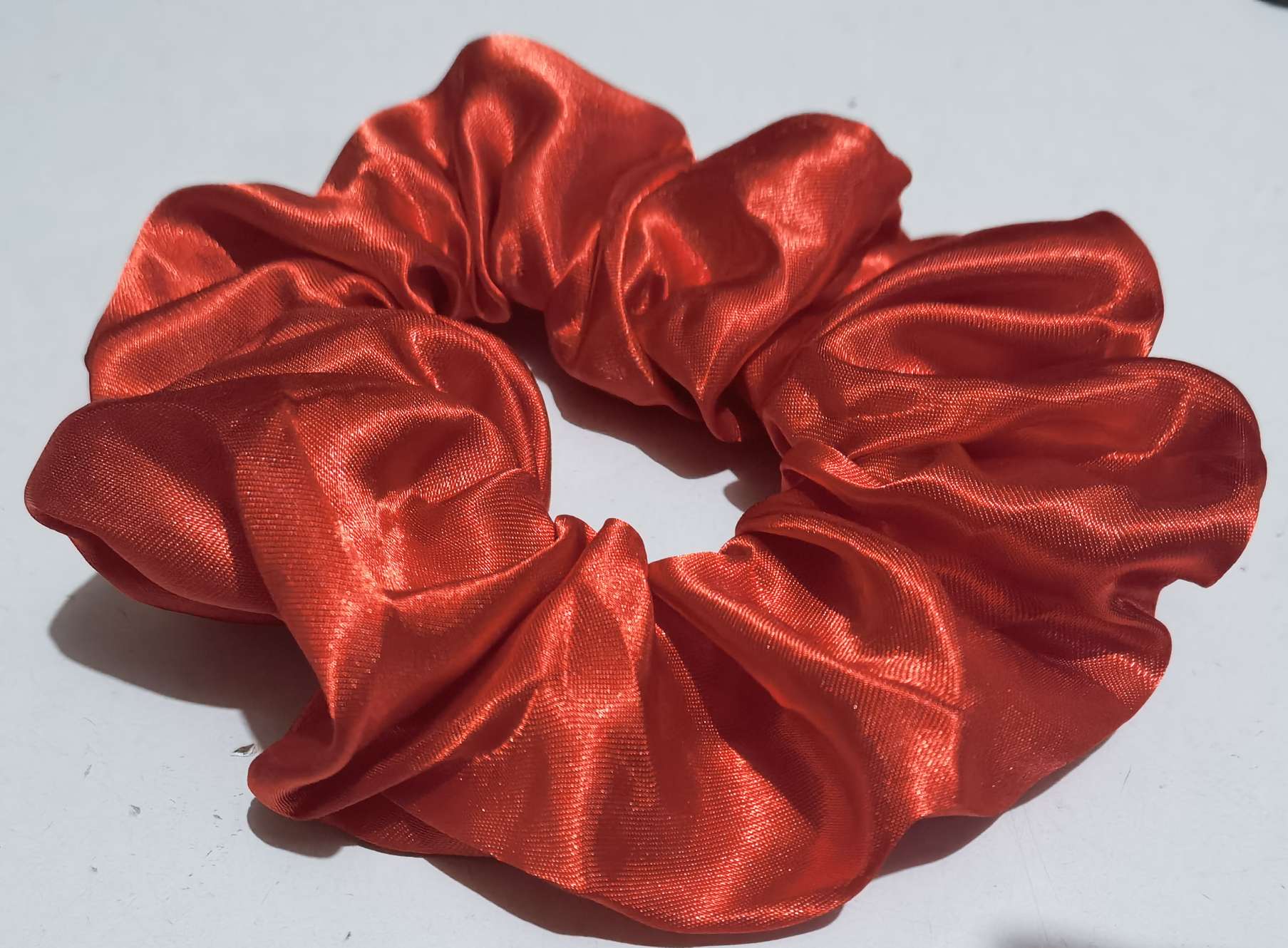 A large red large intestine hair band made of satin