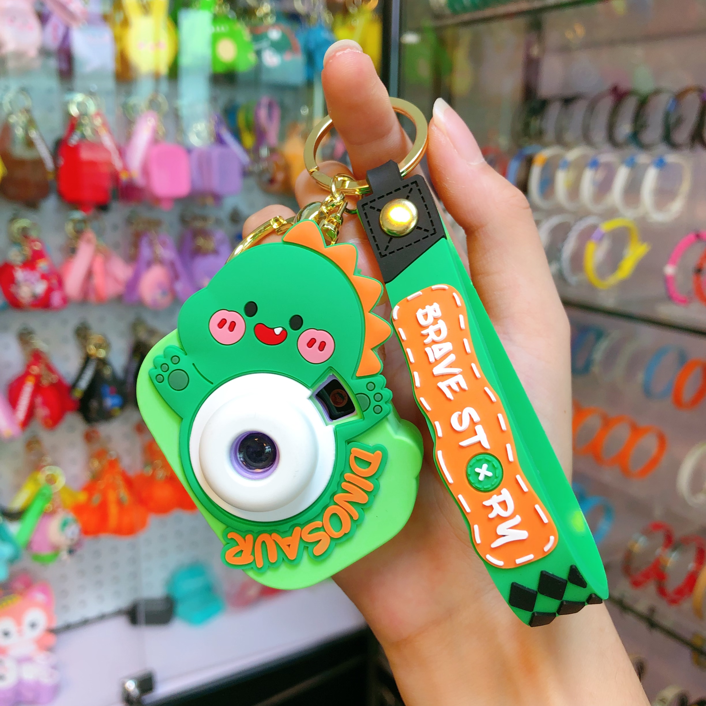 Wholesale of new car car pendants, illuminated key chains, keychains, and cute little figurines with dinosaur cameras Item Picture