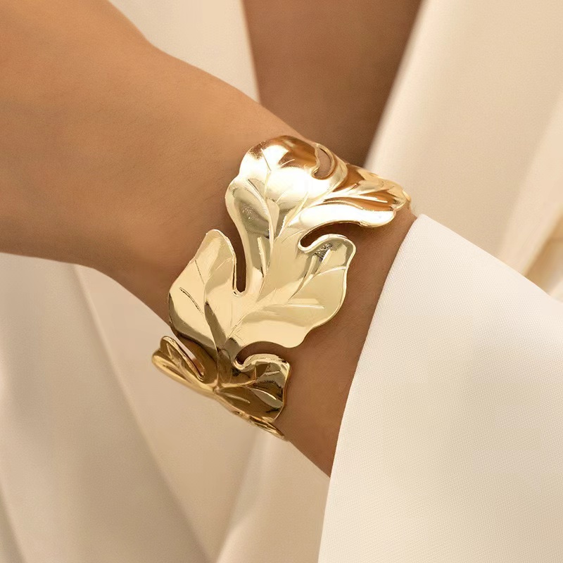 A cross-border bestseller, the golden leaf bracelet, exudes a light luxury and high-end vibe. It's an exaggerated leaf wristband with an open wide version for the catwalk