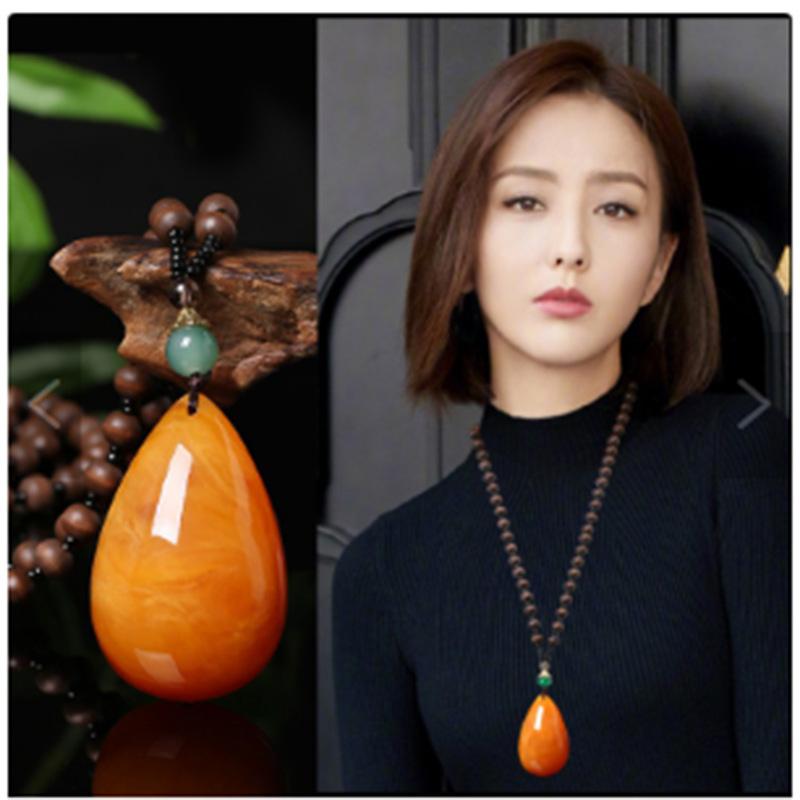 yiwu accessories wholesale ethnic style imitation beeswax water drop necklace core wooden bead long sweater chain women's imitation amber pendant details Picture