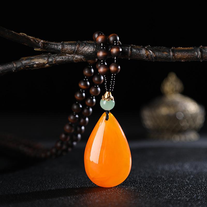 yiwu accessories wholesale ethnic style imitation beeswax water drop necklace core wooden bead long sweater chain women's imitation amber pendant full figure