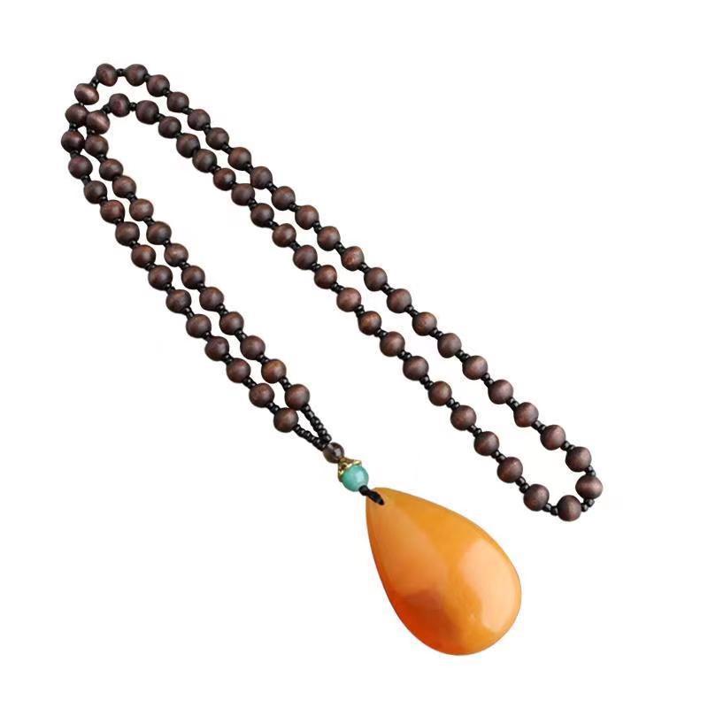 yiwu accessories wholesale ethnic style imitation beeswax water drop necklace core wooden bead long sweater chain women's imitation amber pendant Item Picture
