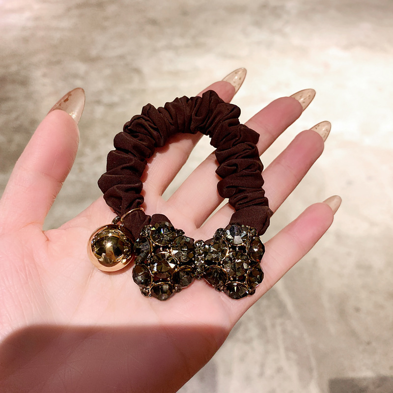A new retro and fashionable Korean style with a bow tie full of diamonds and a French large intestine hair band. A simple ponytail for women with hair bands detail image 4