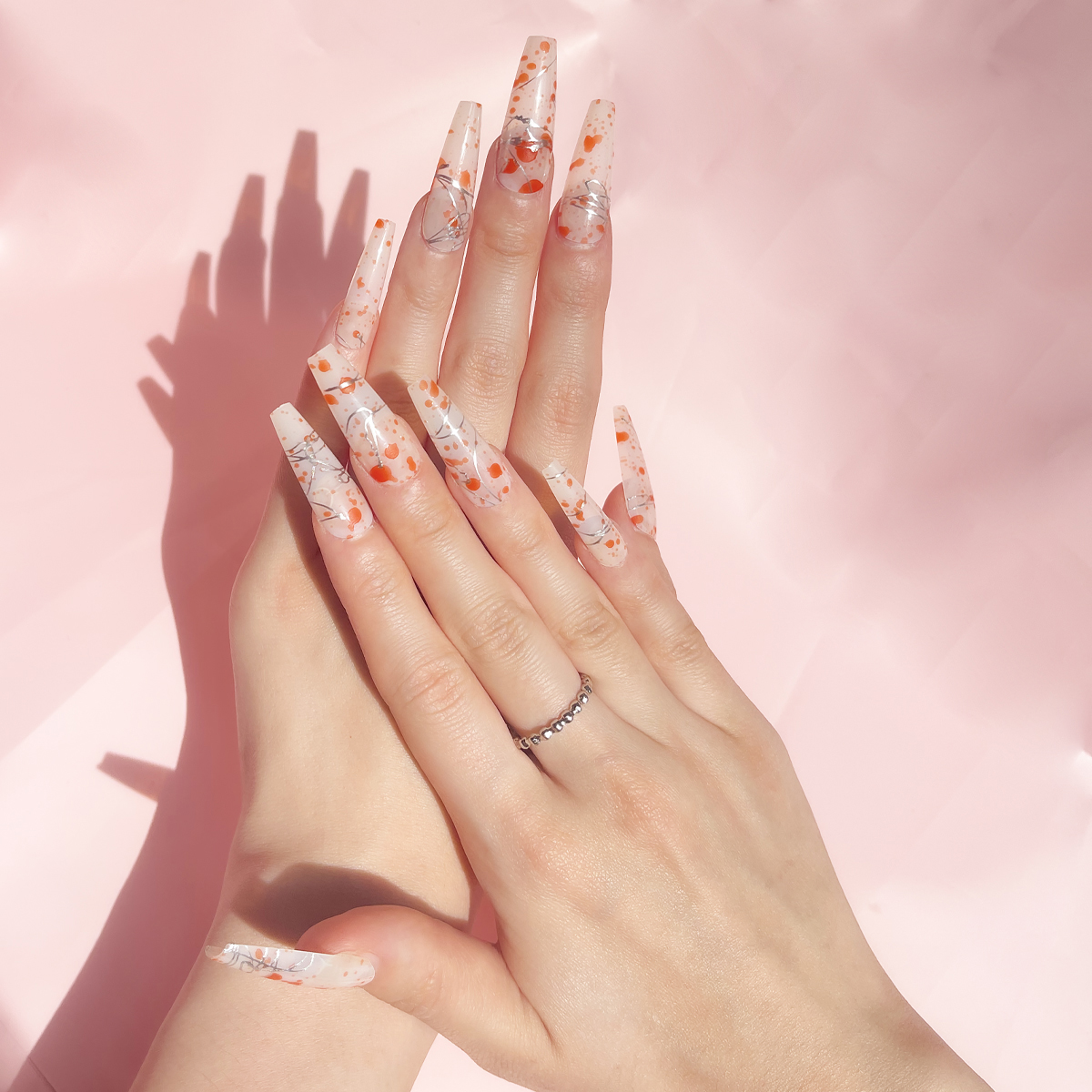 24 PCS PRESS ON NAIL TIPS LONG COFFIN SHAPE SLIVERY LINES AND ORANGE DOTS full figure