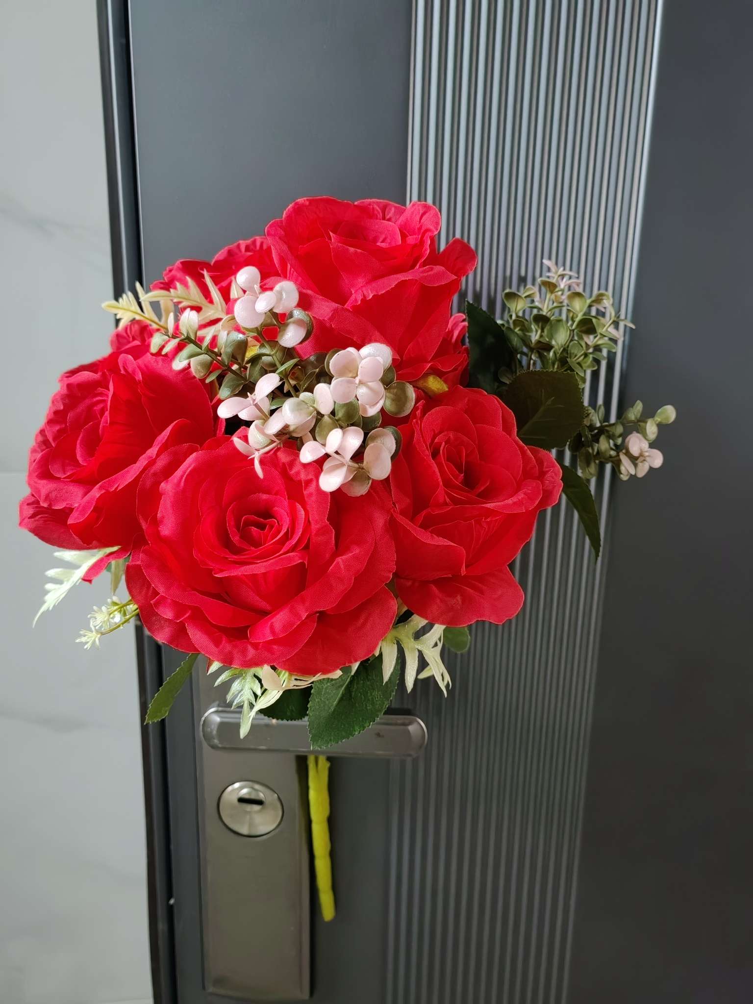 A bouquet of large roses and eucalyptus leaves