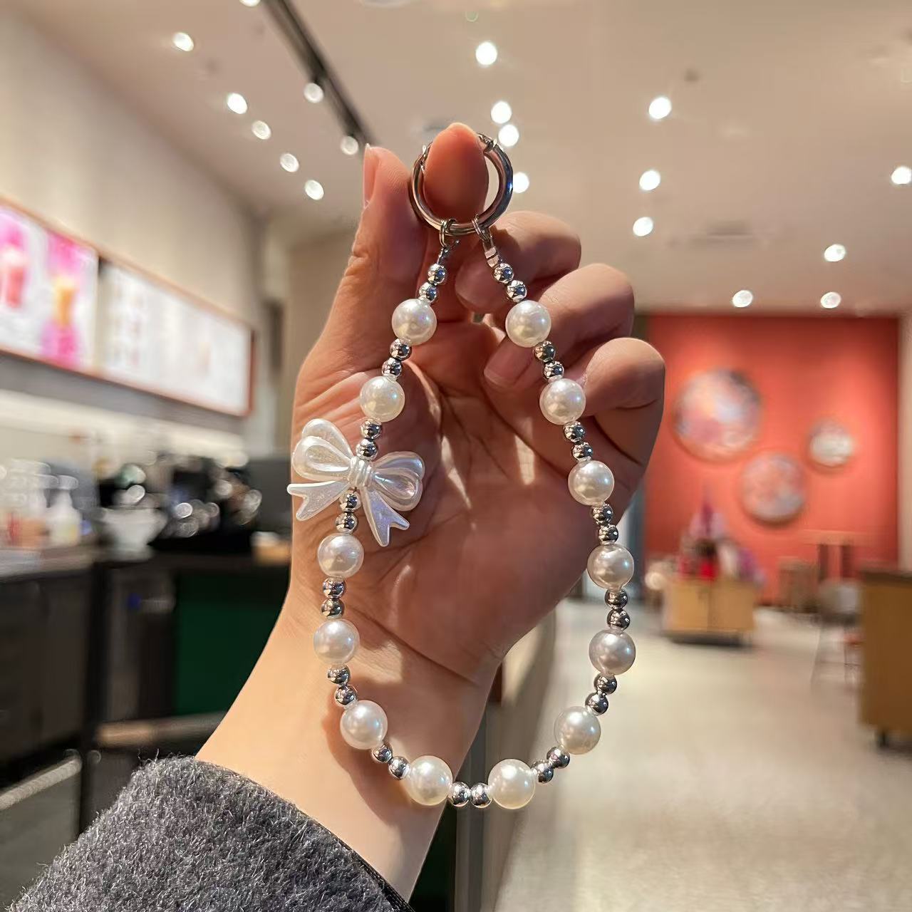 Creative imitation pearl meteor five-pointed star mobile phone chain lanyard, short wrist handcrafted beaded key chain for Japanese and Korean women detail image 4