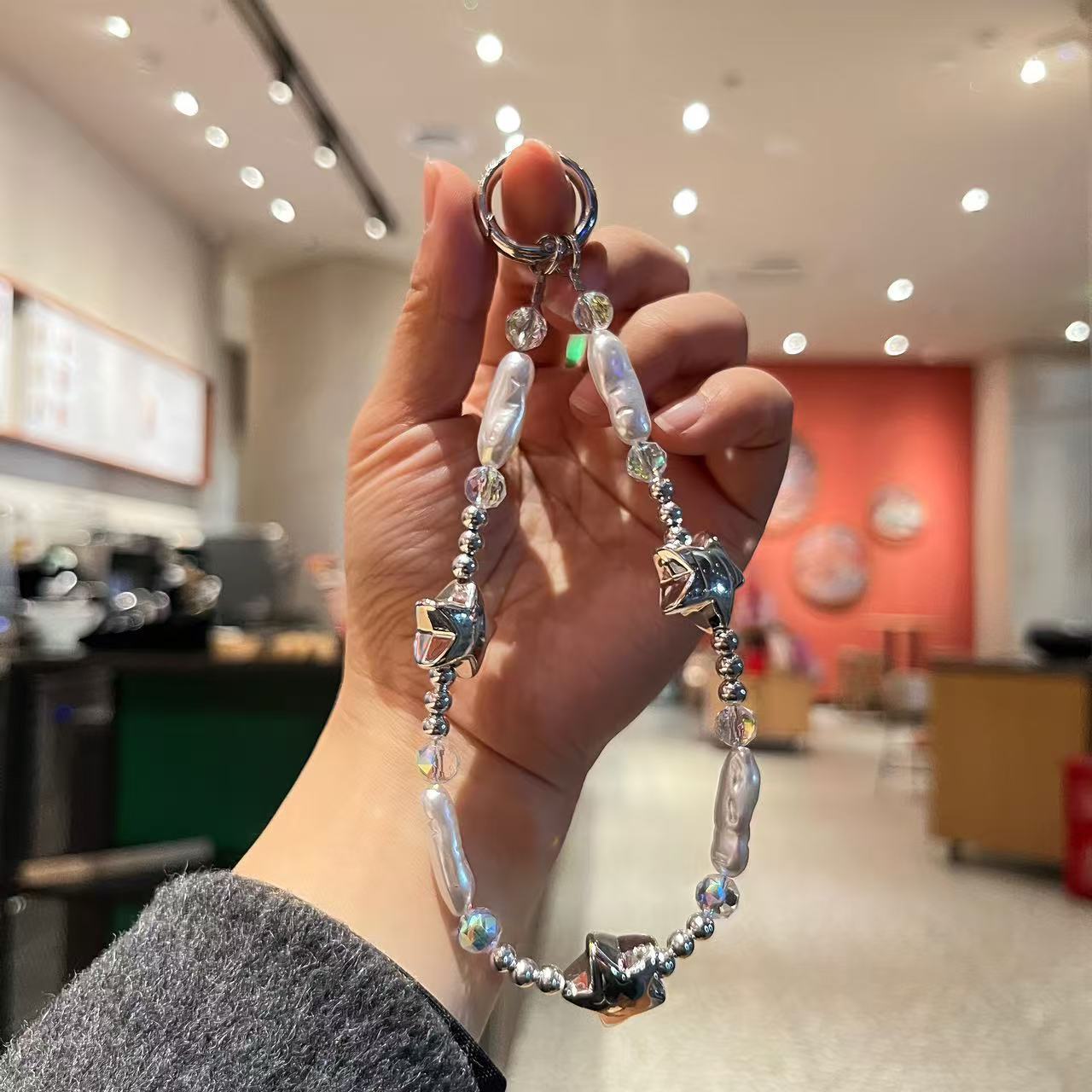 Creative imitation pearl meteor five-pointed star mobile phone chain lanyard, short wrist handcrafted beaded key chain for Japanese and Korean women detail image 2