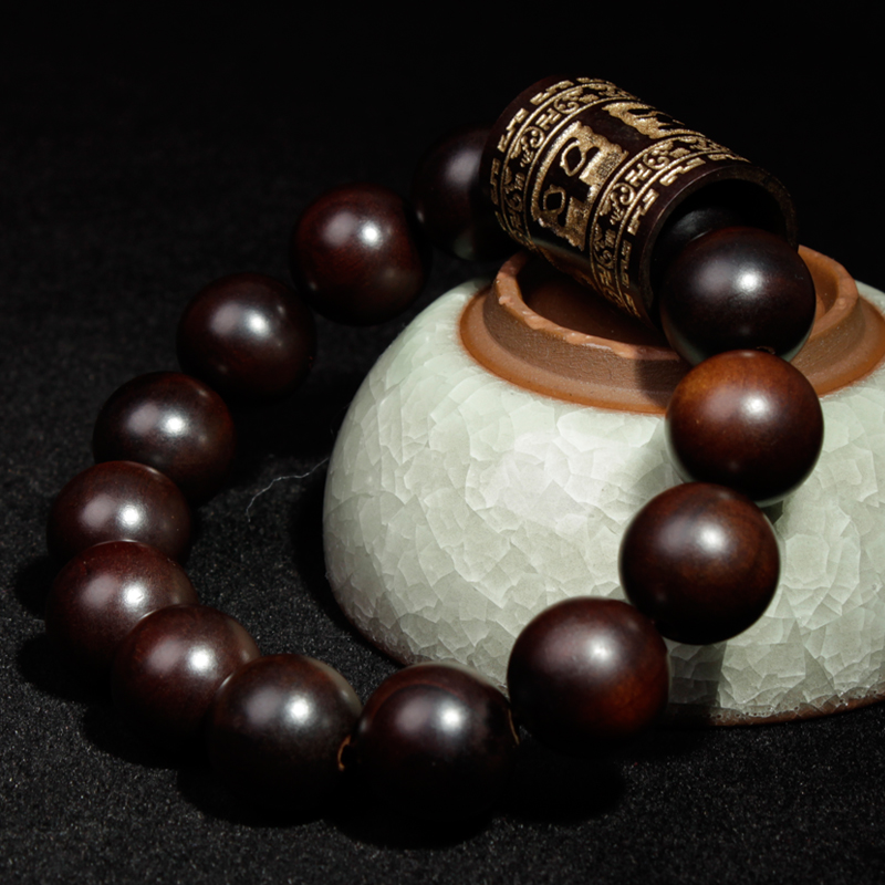 A light-struck jujube wood round bead is engraved through a gold barrel on a 13mm safe men's bracelet details Picture