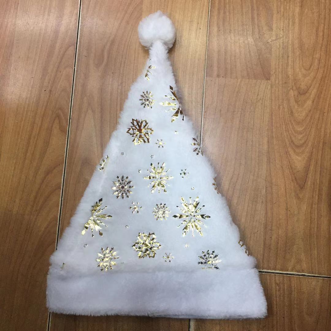 Christmas decorations: White Christmas hats with gold and silver prints and plush edges, adult Christmas hats details Picture