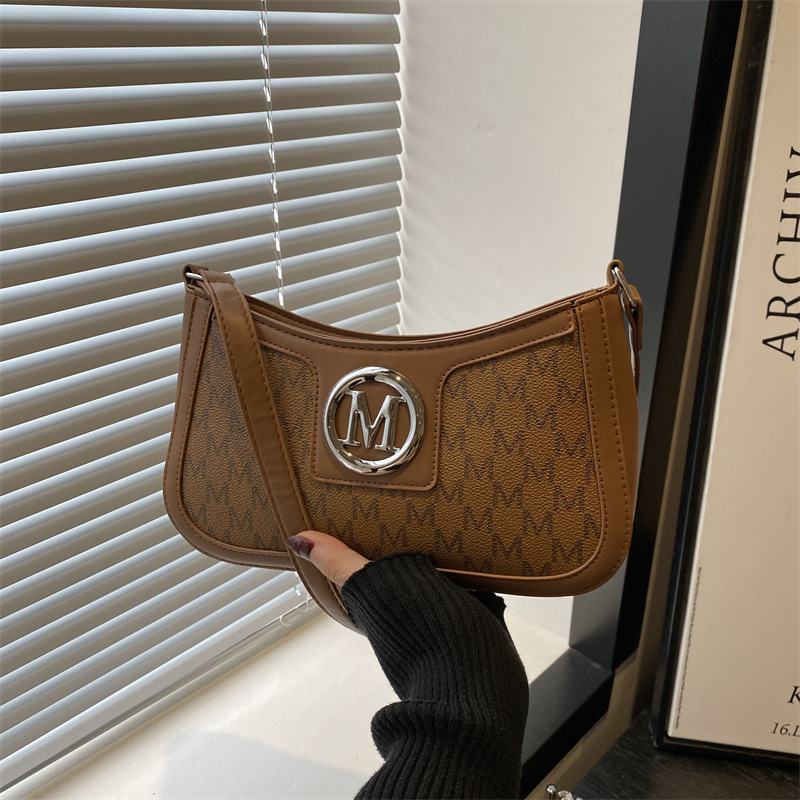 A new, stylish and artistic underarm bag for women in the spring of 2025. A small, unique and simple square bag with letch-printed crossbody full figure