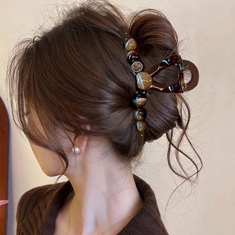 A large coffee-colored clipper for women, with a high-end look at the back of the head, a shark clip for thick hair, a stylish hairpin, and a headpiece details Picture
