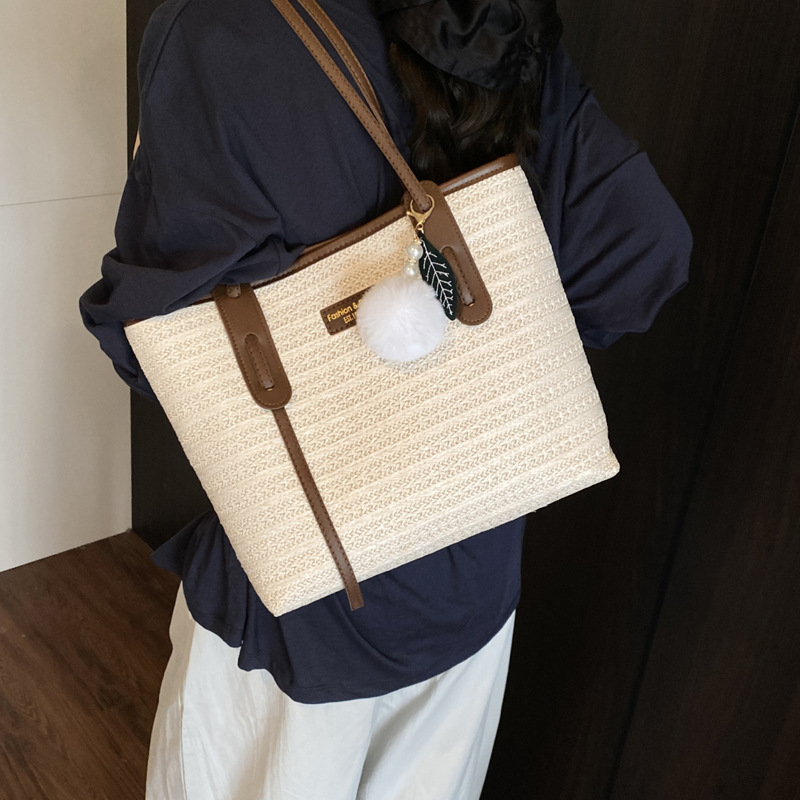 This is a new 2025 summer beach-style women's bag with a simple and versatile hand-held design. It's a single-shoulder vacation woven bag details Picture