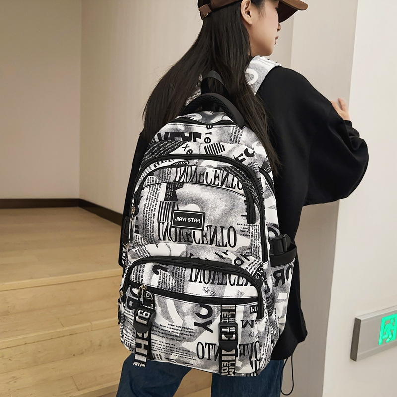 New college student fashionable, durable and large-capacity backpack for junior and senior high school students. High appearance level graffiti camouflage double backpack full figure