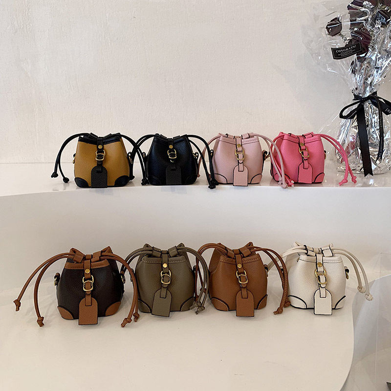 ins European and American style mini children's drawstring bucket in a concave shape, hand-carried crossbody small bag for women full figure