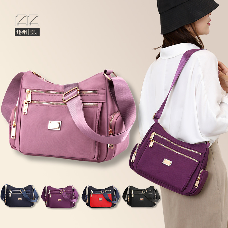 The 2025 new women's crossbody bag, a nylon color-blocking single-shoulder bag, is designed as a large-capacity, multi-layered, simple middle-aged mom bag full figure