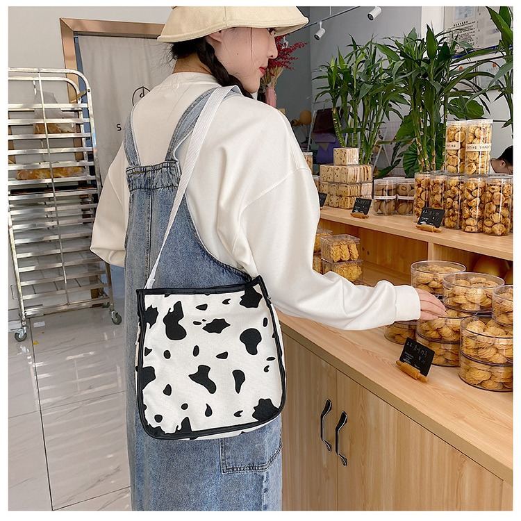 A cute hand-held canvas bag, a new trendy lady's cow pattern Japanese-style small square bag, a Haraju-style striped single-shoulder crossbody bag Application Scenario