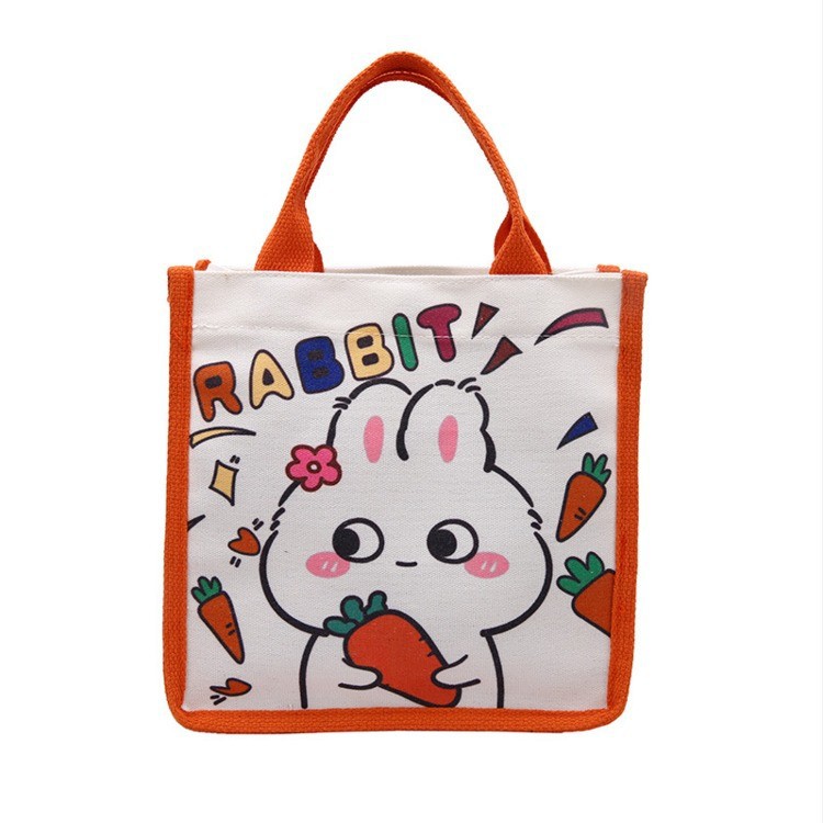 Wholesale of new Japanese-style cute canvas bags with little rabbit prints, cartoon girl tutorial bags, and portable bento bags for going out Item Picture