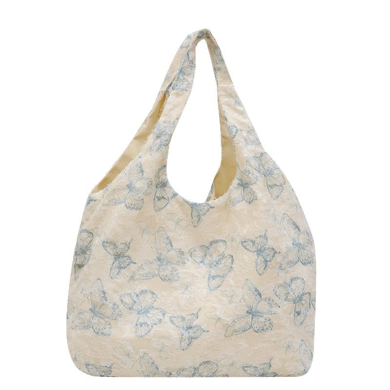 The new large-capacity floral patterned and stylish tote bag with a laid-back style and butterfly print is a casual and fresh hand-held bag Item Picture