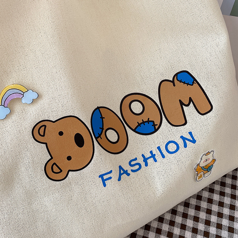 2021 Summer Japanese-style simple canvas bag, student backpack, single-shoulder handbag for going out, cartoon badge cotton bag Application Scenario