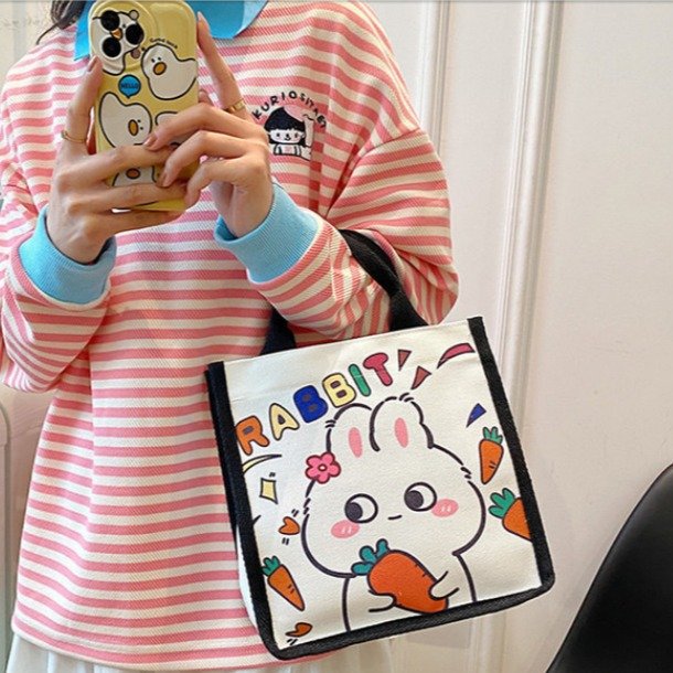 Wholesale of new Japanese-style cute canvas bags with little rabbit prints, cartoon girl tutorial bags, and portable bento bags for going out Application Scenario