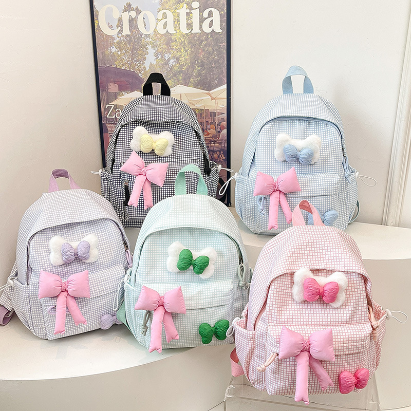 2025 New versatile backpack for students, solid color bow, simple and casual, large-capacity backpack for junior and senior high school full figure
