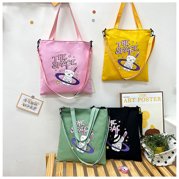 Cute student canvas bags in stock and hot sale. Cartoon rabbit printed tote bags, fashionable and simple shopping bags wholesale full figure