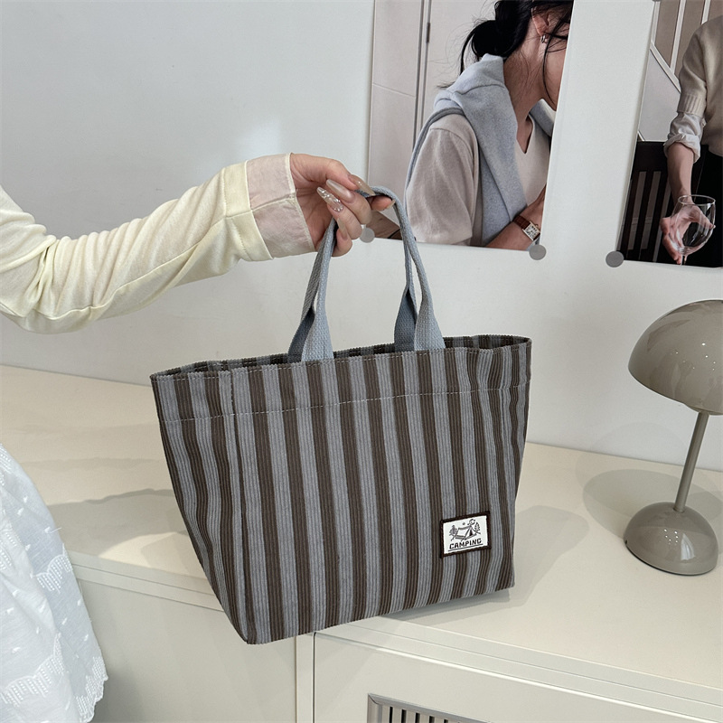 Striped canvas bag for women 2025 new style, fashionable and artistic hand-held bag, large-capacity tote bag for work and commuting Application Scenario