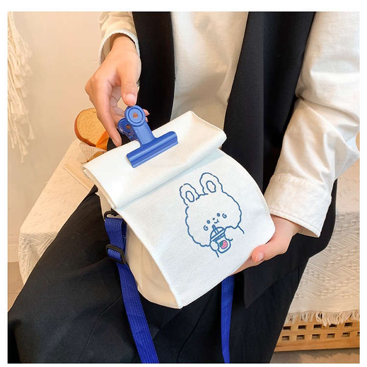 A versatile canvas bag for women in stock, a new student Korean version crossbody bag, a large-capacity Japanese style simple cartoon clip bag Application Scenario