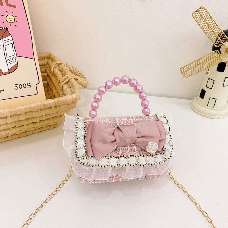 A cute princess crossbody bag with a bow, a trendy children's pearl handbag details Picture