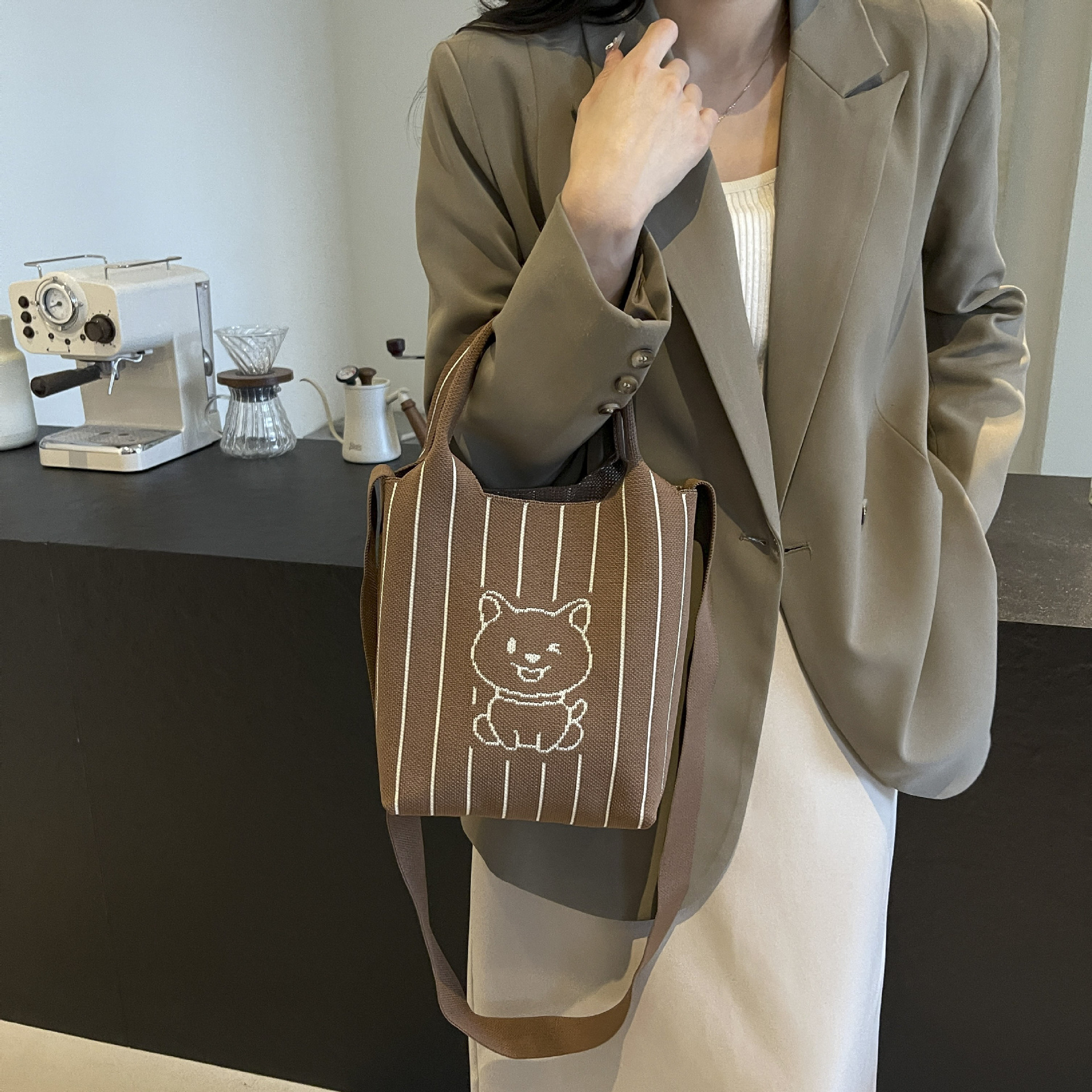 This handbag is a stylish knitted striped shopping bag. It's a popular lady's bear large-capacity tote single-shoulder bag for going out details Picture