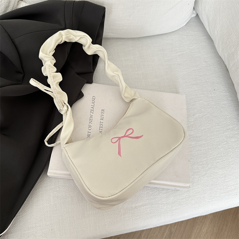 The new French-style niche design single-shoulder bag with a solid color bow underarm bag and simple pleated small handbag in 2025 is selling well details Picture
