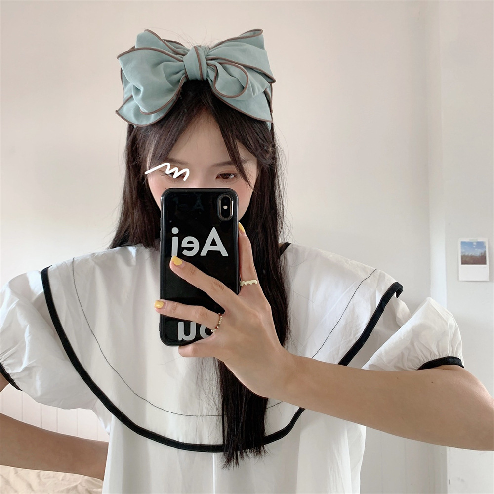 26123 Early Spring new ins three-dimensional printed plain color bow hairpin for facial slimming and facial enhancement Application Scenario