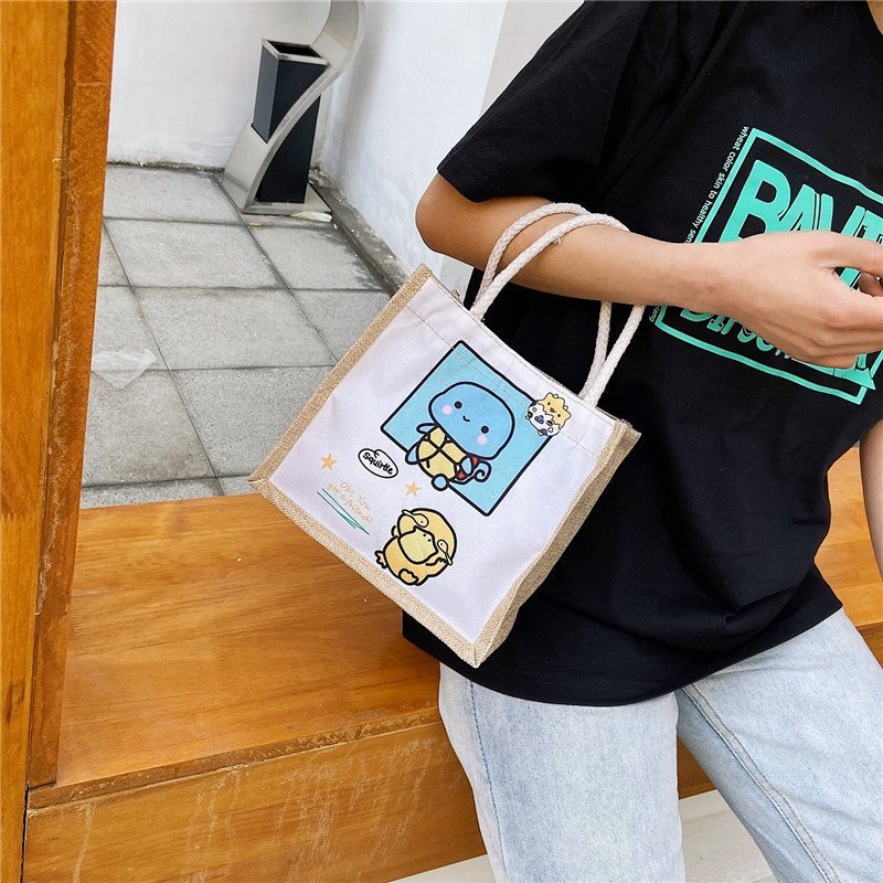 New canvas bag, a cute cartoon handbag for female students, a fresh and fashionable women's bag, and a casual hand-held small bag details Picture