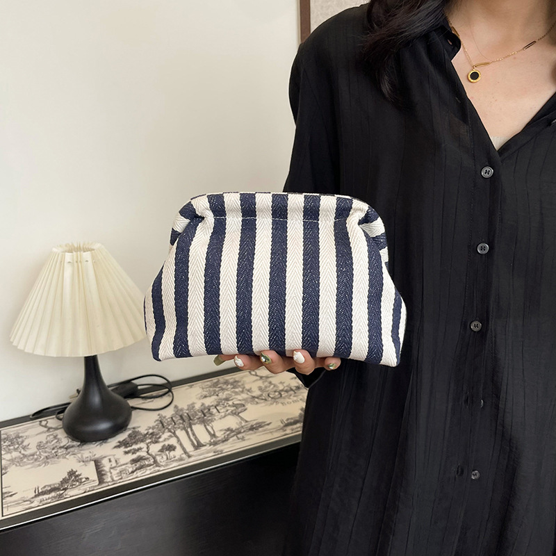 New cross-border fashion color-blocking striped cosmetic bag, women's loose change mobile phone storage bag, trendy and niche cloud clutch full figure