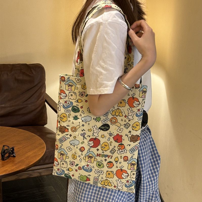 Cute cartoon 2025 new single-shoulder canvas bag, large capacity cloth bag, student tote storage, makeup bag, portable bag full figure