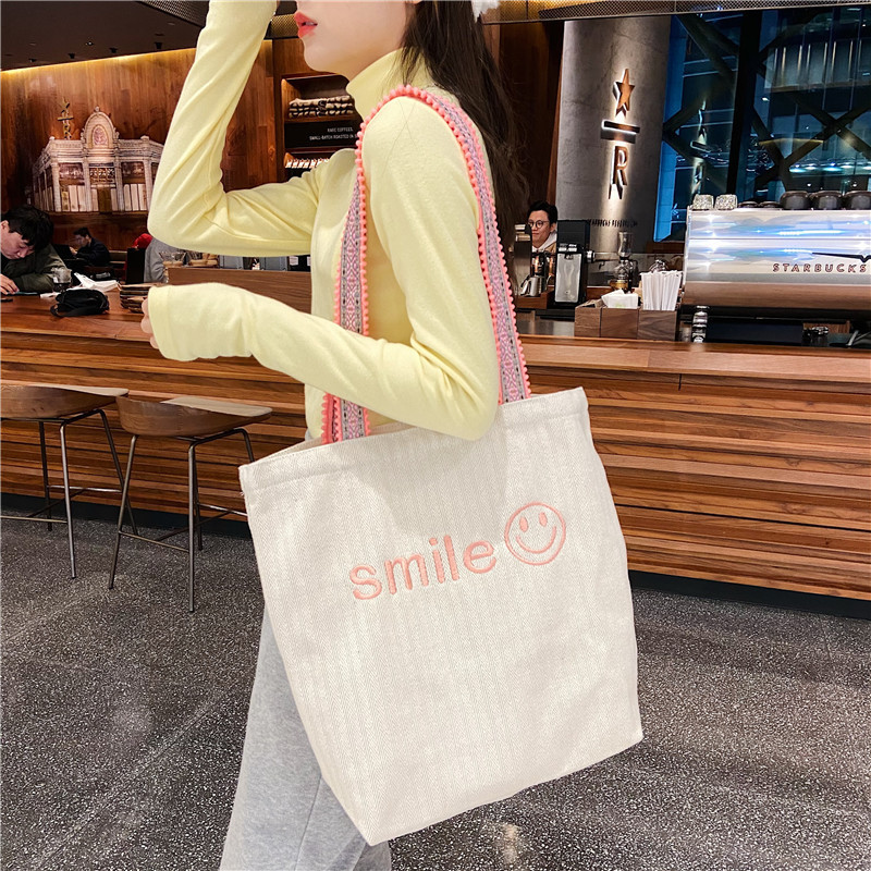 1119 Korean ins embroidered smiling face large-capacity single-shoulder bag with pom-pom shoulder strap for students' class girls canvas bag wholesale Application Scenario