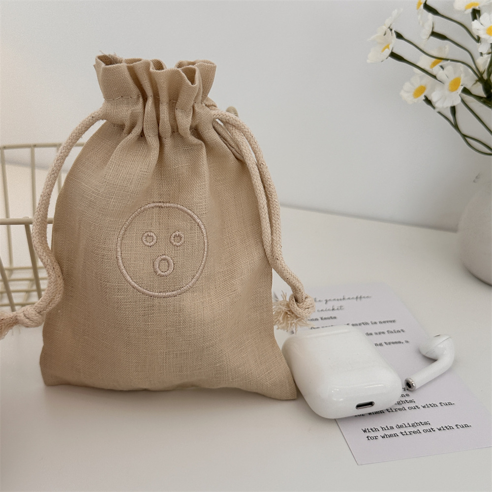 44122 Storage bag, linen embroidered smiling face, portable dust-proof bag for miscellaneous items, small drawstring drawstring pocket Item Picture