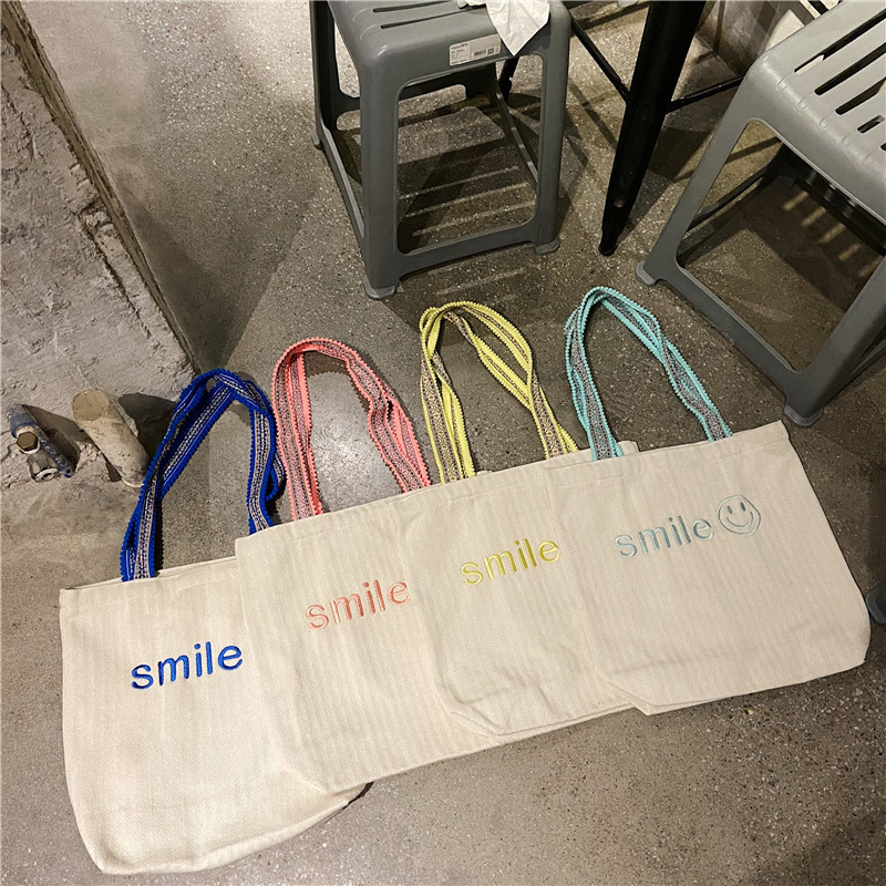 1119 Korean ins embroidered smiling face large-capacity single-shoulder bag with pom-pom shoulder strap for students' class girls canvas bag wholesale full figure