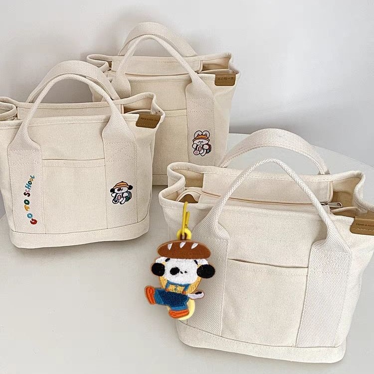 A cute Japanese-style canvas bag with dog letters, a new style for women, a handbag for moms going out, a bento bag, and a handbag for office workers full figure